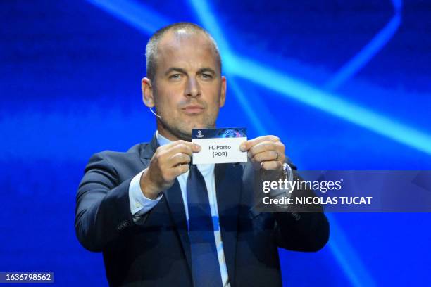 English former football player Joe Cole shows the paper slip of FC Porto during the draw for the 2023/2024 UEFA Champions League football tournament...