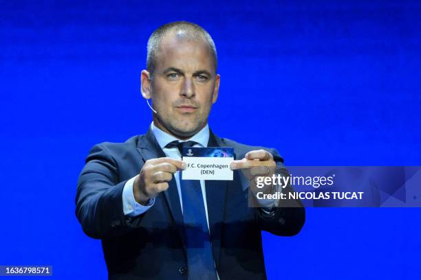English former football player Joe Cole shows the paper slip of FC Copenhagen during the draw for the 2023/2024 UEFA Champions League football...