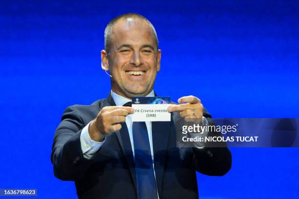 English former football player Joe Cole shows the paper slip of FK Crvena zvezda during the draw for the 2023/2024 UEFA Champions League football...