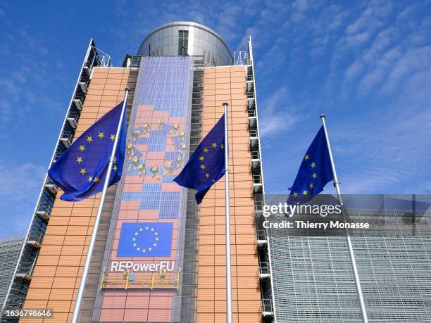 The flags of the European Union flutter in the winds in front of the Berlaymont, the EU Commission headquarter on August 31, 2023 in Brussels,...