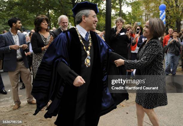 Peter Salovey dances with his wife Marta Elisa Moret to some bluegrass music played by the Deadly Gentlemen during a block party to celebrate after...