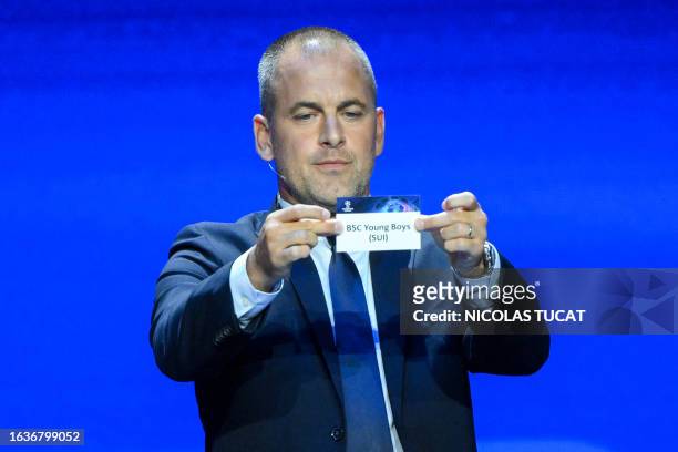 English former football player Joe Cole shows the paper slip of BSC Young Boys during the draw for the 2023/2024 UEFA Champions League football...