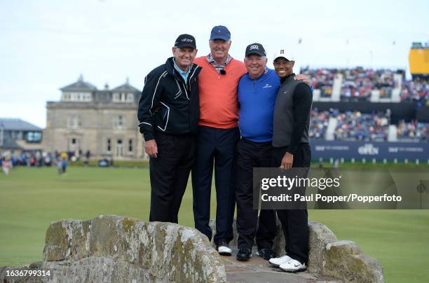 Former winners Nick Price, Tom Weiskopf, Mark O'Meara and Tiger Woods pose on the Swilcan Bridge during the Champion Golfers' Challenge the day...