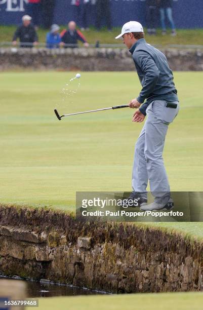 Jordan Spieth of the United States retrieves the ball from the water during the final practice day before the 144th Open Championship at the Old...