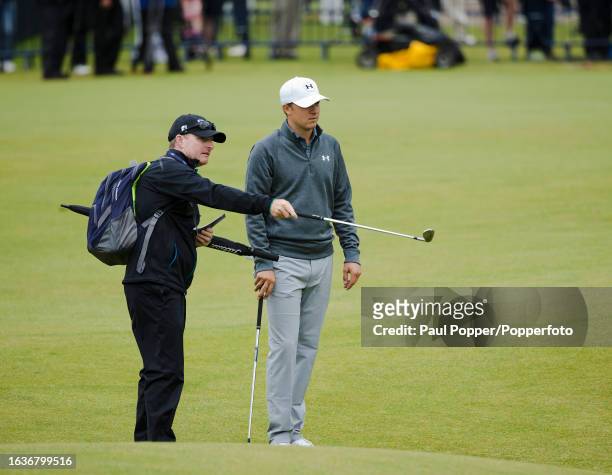 Jordan Spieth of the United States receives instructions from his coach Cameron McCormick during the final practice day before the 144th Open...