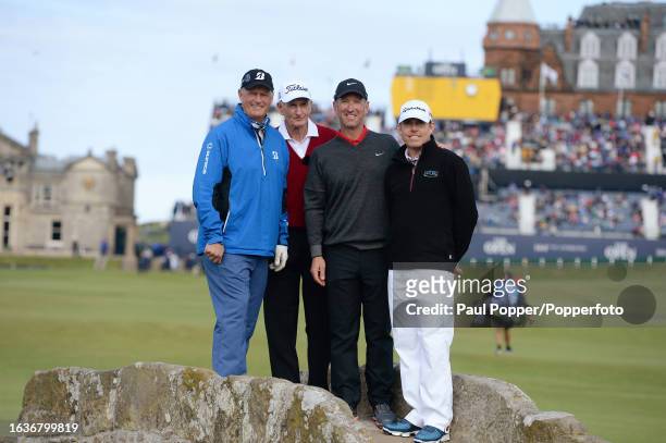 Former winners Sandy Lyle, Bob Charles, David Duval and Justin Leonard pose on the Swilcan Bridge during the Champion Golfers' Challenge the day...