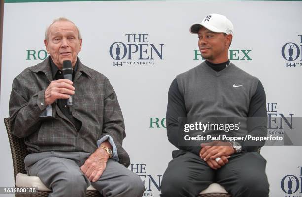 Tiger Woods of the United States in conversation with former United States golfer Arnold Palmer during the Champion Golfers' Challenge the day before...