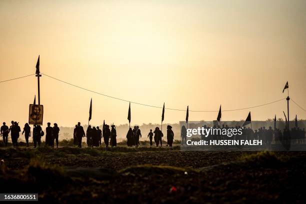 Shiite Muslim pilgrims march through Iraq's southern province of Diwaniyah early on August 31, 2023 on the way to the central Iraqi shrine city of...