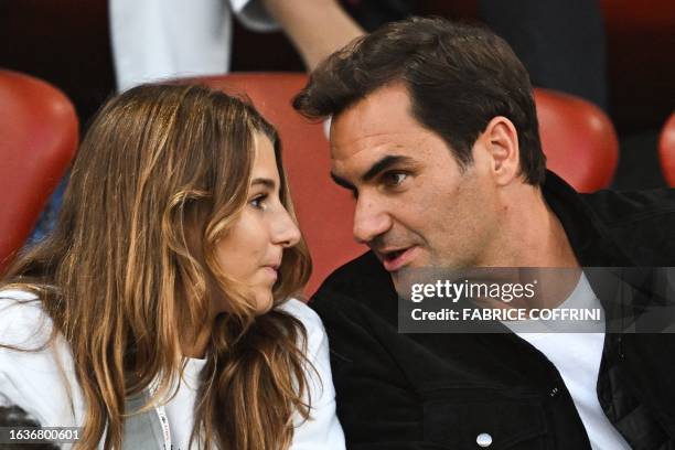 Former Swiss tennis player Roger Federer speak with one of his daughters during the Diamond League athletics meeting at Stadion Letzigrund stadium in...