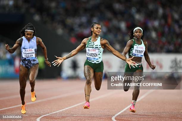 Sha'Carri Richardson celebrates as she crosses the finish line to win the women's 100m final during the Diamond League athletics meeting at Stadion...