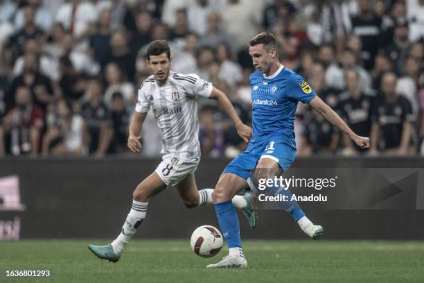 Salih Ucan of Besiktas in action against Vladyslav Vanat of Dynamo Kyiv during the UEFA Europa Conference League play-off second leg match between...