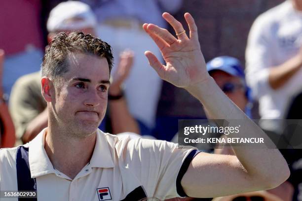 S John Isner waves after losing against USA's Michael Mmoh during the US Open tennis tournament men's singles second round match at the USTA Billie...