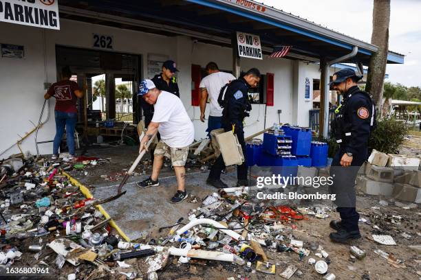 Members of the Miami-Dade Fire Rescue Florida Task Force 1 help residents to remove debris after Hurricane Idalia in Horseshoe Beach, Florida, US, on...