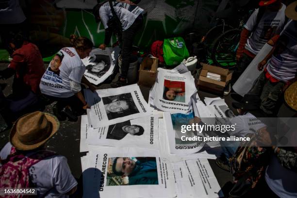 August 2023, Mexico, Mexiko-Stadt: People prepare pictures of missing people on International Day of the Disappeared. Through the day of remembrance,...