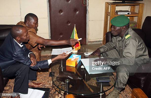 Captain Amadou Haya Sanogo , who emerged from obscurity to lead a coup in March 2012, answers questions during an interview by the director of the...