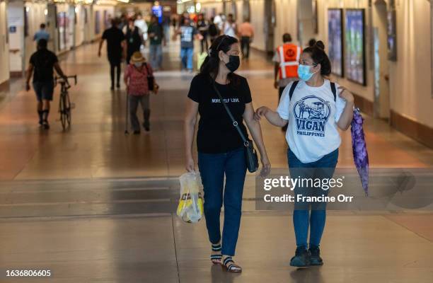Los Angeles, CA Merle Hombrebueno, left, and Gerlie Pelagio, right, are wearing a face mask in Union Station on Thursday, Aug. 31 in Los Angeles, CA....