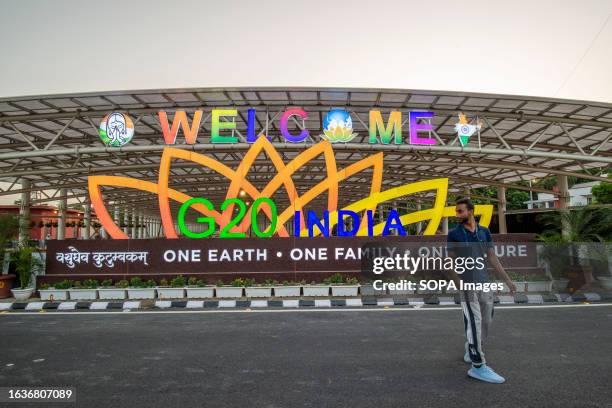 Man walks past an illuminated G20 logo outside the main Venue of the G20 Summit in Pragati Maidan. The G20 Summit, which is scheduled to be held in...