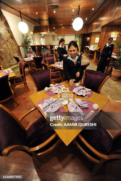 By Nasir Jaffry This picture taken on December 24, 2008 shows employees at one of the eight newly re-build restaurants decorate tables at the...