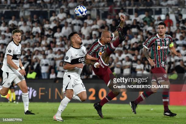 Olimpia's forward Fernando Cardozo and Fluminense's midfielder Felipe Melo fight for the ball during the Copa Libertadores quarterfinals second leg...