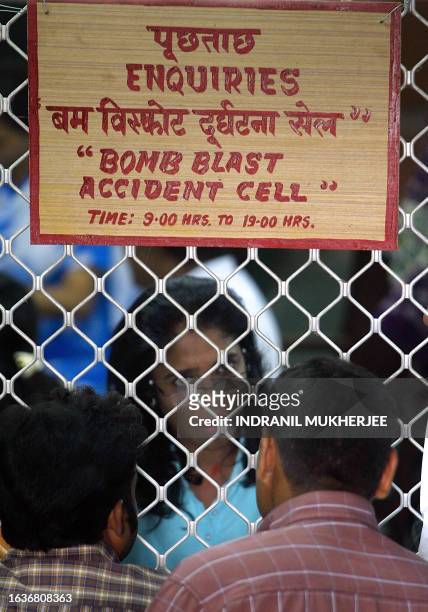 An Indian railway official speaks with family members of bomb blast vicitms as they file compensation forms in Mumbai, 17 July 2006. Family members...
