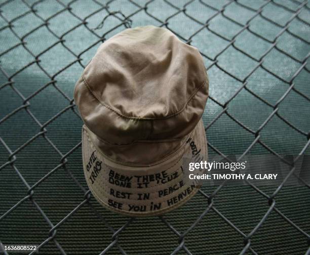 An Army cap hangs on the fence during the ringing of the bell to signify the 1st attack in front of ground zero at the World Trade Center site,11...