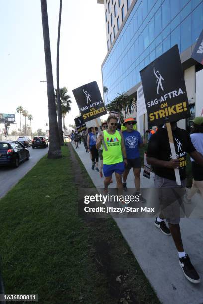 Adam Conover walks the picket line in support of the SAG-AFTRA and WGA strike on August 31, 2023 at Netflix Studios in Hollywood, California.