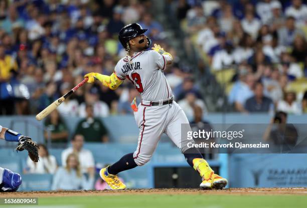 Ronald Acuna Jr. #13 of the Atlanta Braves hits a grand slam home run against starting pitcher Lance Lynn of the Los Angeles Dodgers during the...