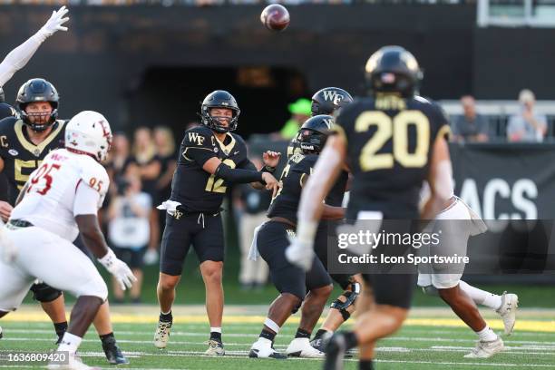 Mitch Griffis of the Wake Forest Demon Deacons passes the ball to Cameron Hite during a football game against the Elon Phoenix at Allegacy Federal...