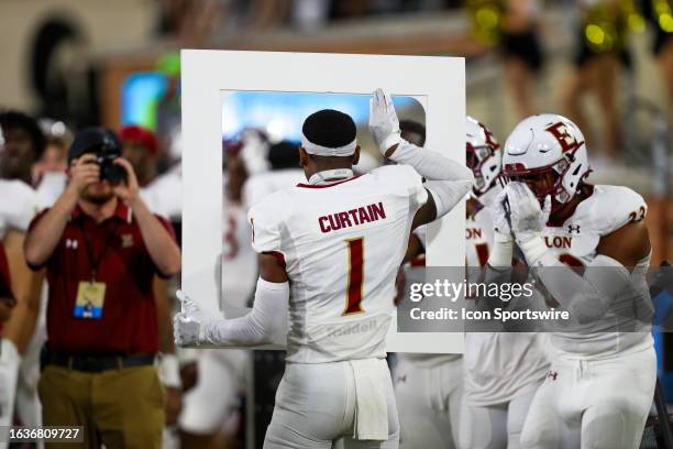 Caleb Curtain of the Elon Phoenix celebrates with a photo after returning an interception for a touchdown during a football game against the Wake...