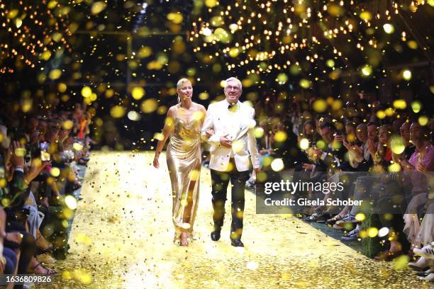 Model Karolina Kurkova and Founder and CEO Helmut Schlotterer walk the runway during the Marc Cain 50 years anniversary fashion show event...