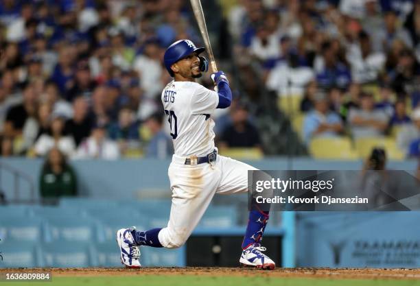 Mookie Betts of the Los Angeles Dodgers hits a three-run home run against starting pitcher Spencer Strider of the Atlanta Braves during the fifth...