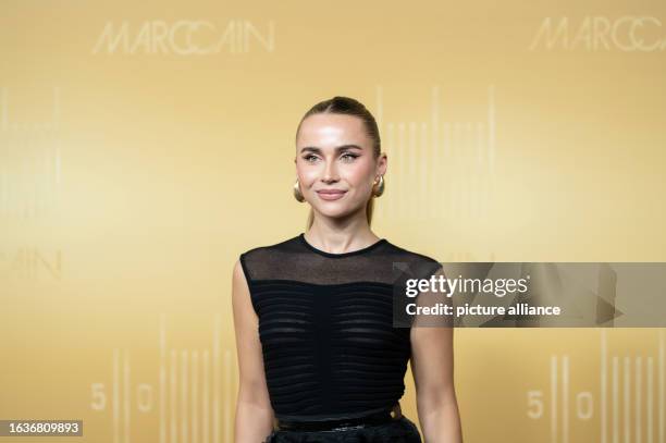 August 2023, Baden-Württemberg, Bodelshausen: Ann-Kathrin Götze stands on the red carpet at the Marc Cain headquarters during the anniversary fashion...