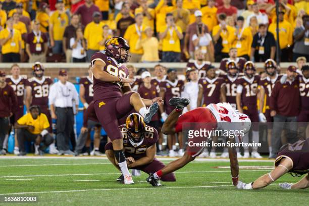 Minnesota Golden Gophers place kicker Dragan Kesich kicks the game winning field goal durning the fourth quarter of the college football game between...