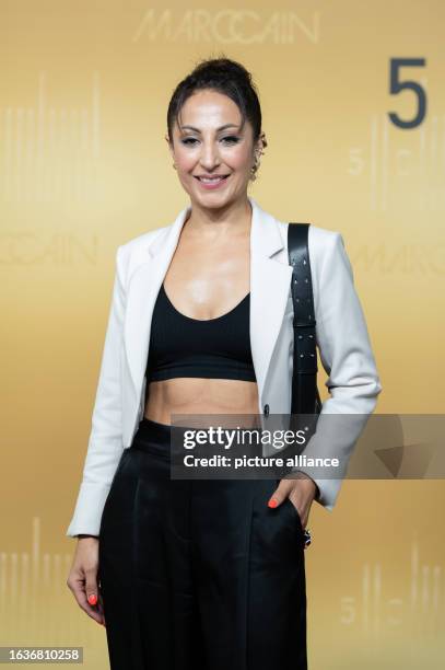 August 2023, Baden-Württemberg, Bodelshausen: Youtuber Anna Nooshin stands on the red carpet at Marc Cain headquarters during the anniversary fashion...