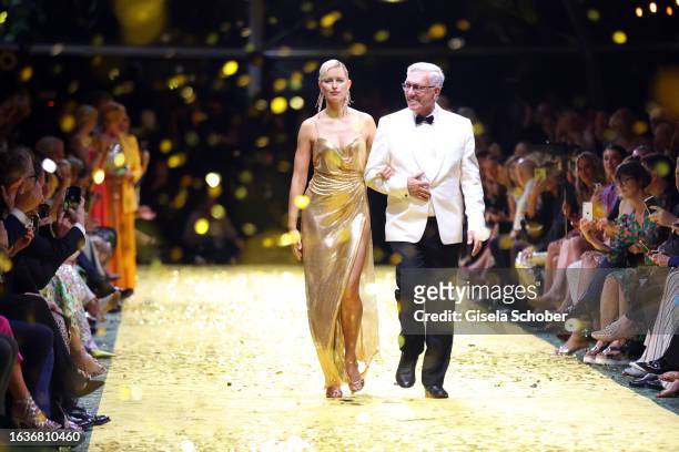 Model Karolina Kurkova and Founder and CEO Helmut Schlotterer walk the runway during the Marc Cain 50 years anniversary fashion show event...