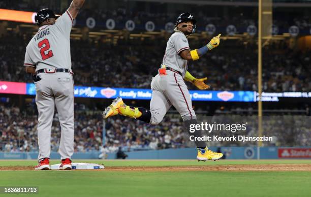 Ronald Acuna Jr. #13 of the Atlanta Braves celebrates his grand slam home run against starting pitcher Lance Lynn of the Los Angeles Dodgers with...