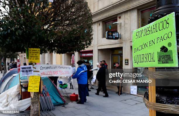 Placard reading "Stop evictions. In lieu of payment. Social rent" is seen during a demonstration in front of a Caja Laboral bank succursal in Burgos,...