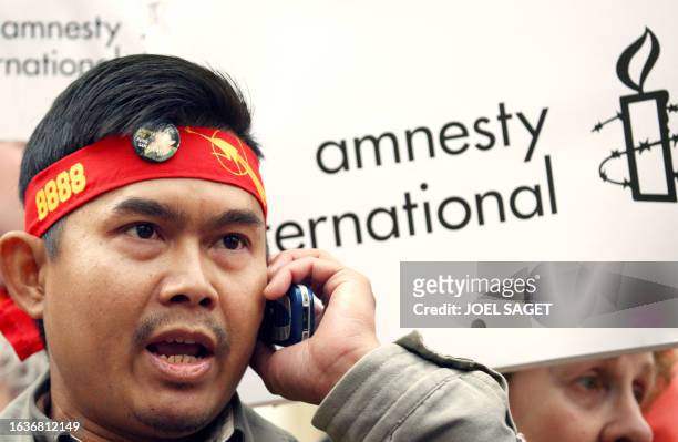 Protester speaks on a phone during a Myanmar's National League for Democracy against Myanmar's military rulers rally in front of the Myanmar embassy...