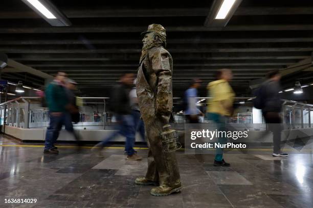 Jose Miguel Moctezuma, better known as ''Don Ferro Ferrocarrilero'', a living statue, travels through different stations of the Metro Collective...