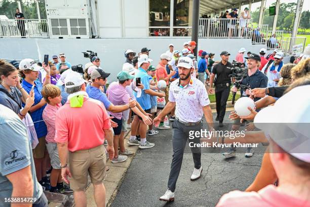 Max Homa greets fans as he walks off the 18th hole green during the final round of the TOUR Championship, the third and last event of the FedExCup...