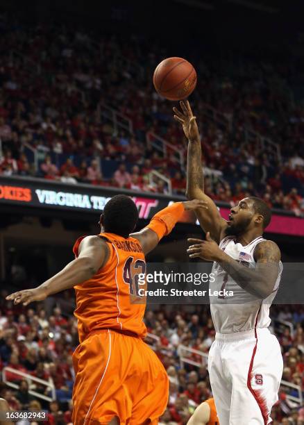 Richard Howell of the North Carolina State Wolfpack shoots over C.J. Barksdale of the Virginia Tech Hokies during the first round of the Men's ACC...