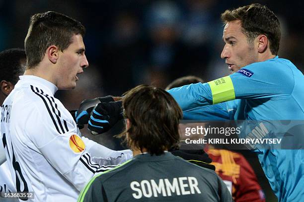 Zenit St. Petersburg's football player Roman Shirokov scuffles with FC Basel 1893's player Fabian Schar during their UEFA Europe League round of 16...