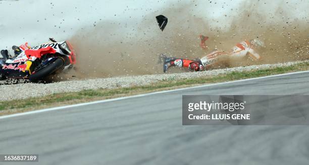 Honda Spanish rider Marc Marquez crashes during the first MotoGP free practice session of the Moto Grand Prix of Catalonia at the Circuit de...