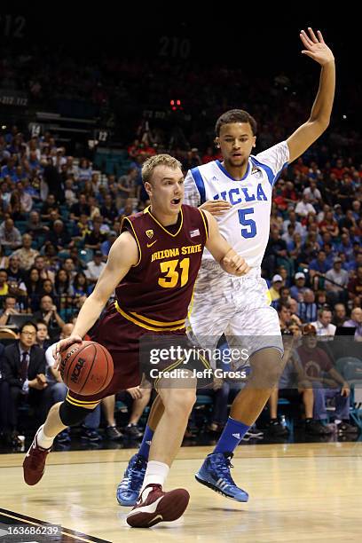 Jonathan Gilling of the Arizona State Sun Devils drives on Kyle Anderson of the UCLA Bruins in the first half during the quarterfinals of the Pac-12...