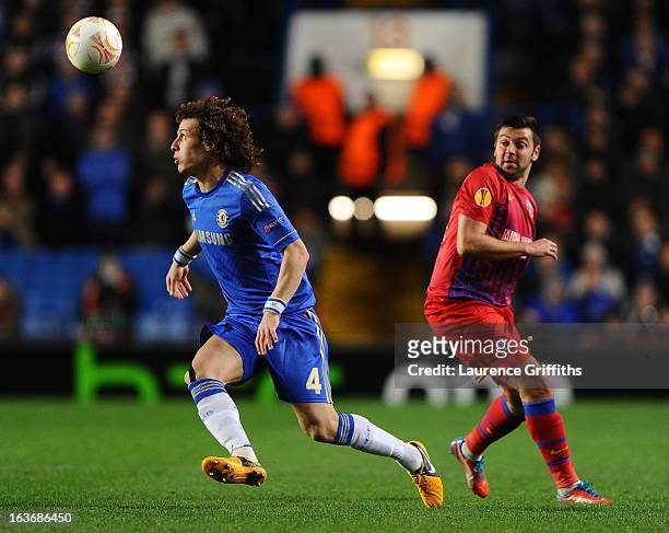 David Luiz of Chelsea beats Raul Rusescu of FC Steaua Bucuresti to the ball during the UEFA Europa League Round of 16 Second leg match between...
