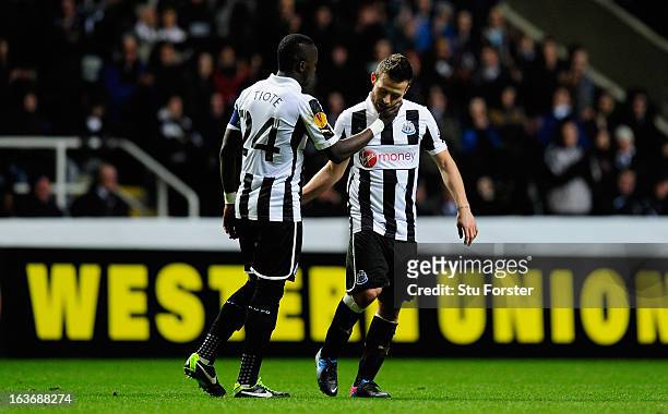 Newcastle player Cheick Tiote consoles captain Yohan Cabaye after he was forced off due to injury during the UEFA Europa League Round of 16 second...