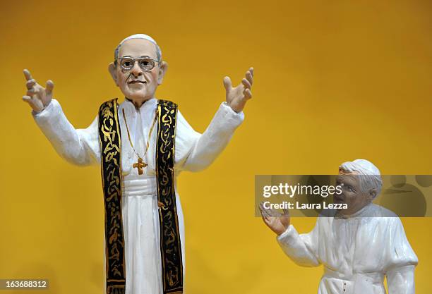 Commemorative figurine, created by artisan Genny Di Virgilio, depicting Pope Francis is displayed next to a Pope Benedict XVI figurine at San...