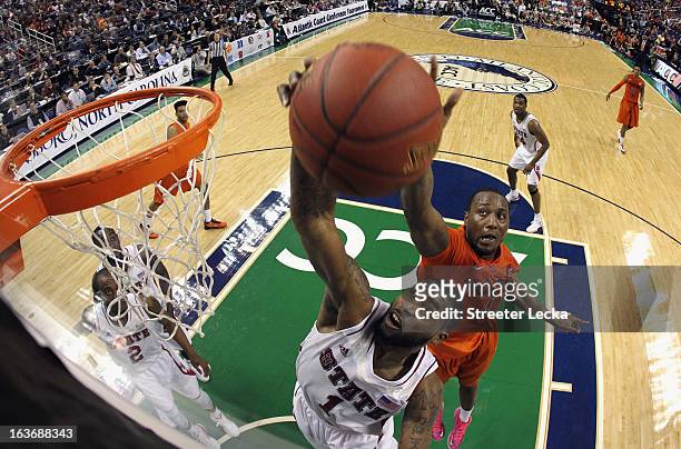 Richard Howell of the North Carolina State Wolfpack and Cadarian Raines of the Virginia Tech Hokies battle for a rebound during the first round of...