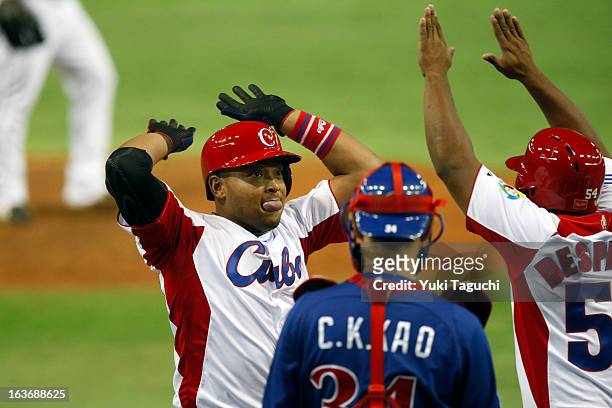 Yasmany Tomas of Team Cuba celebrates with Alfredo Despaigne of Team Cuba at home plate after hitting a three run home run in the bottom of the...