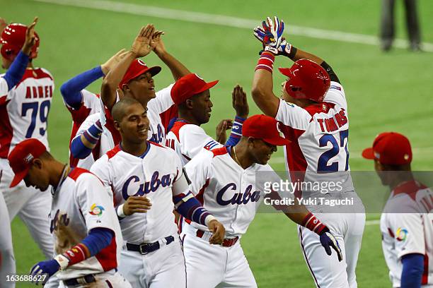 Yasmany Tomas of Team Cuba celebrates with teammates after hitting a three run home run in the bottom of the fourth inning during Pool 1, Game 3...